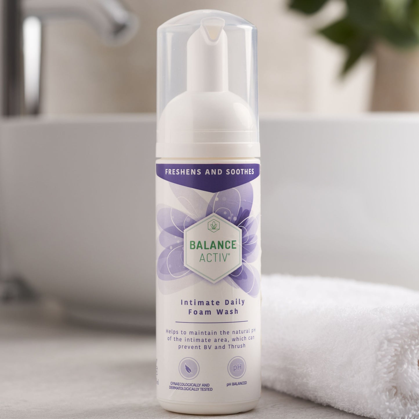 Foam wash bottle labeled 'Balance Activ' on a bathroom counter with a blurred background